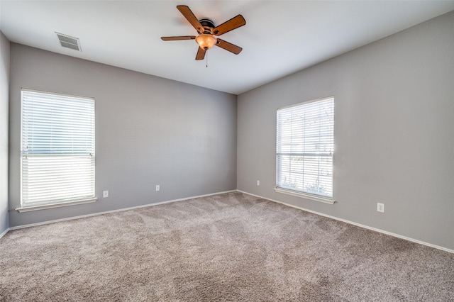 empty room with ceiling fan and carpet