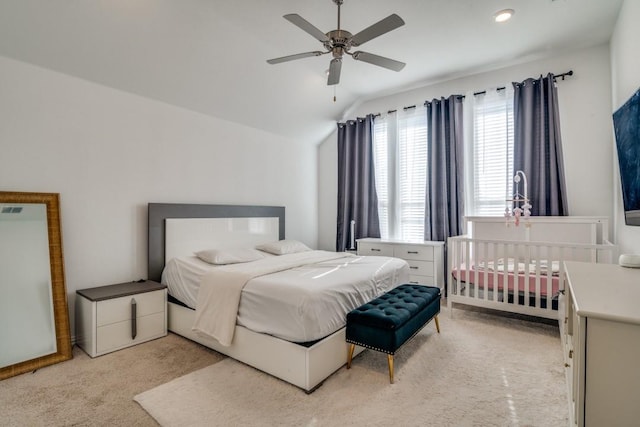 bedroom featuring ceiling fan, light carpet, and vaulted ceiling