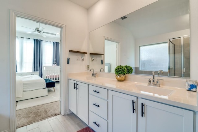 bathroom with vanity, ceiling fan, and walk in shower