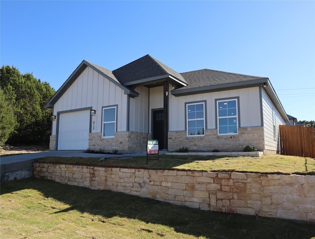 view of front facade with a garage and a front lawn