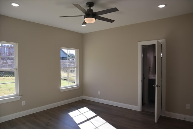 spare room with ceiling fan and dark hardwood / wood-style flooring