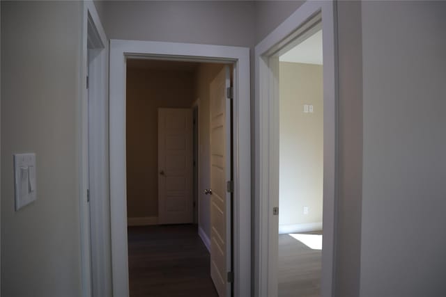 hall with dark hardwood / wood-style flooring