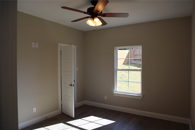 spare room with dark hardwood / wood-style floors and ceiling fan