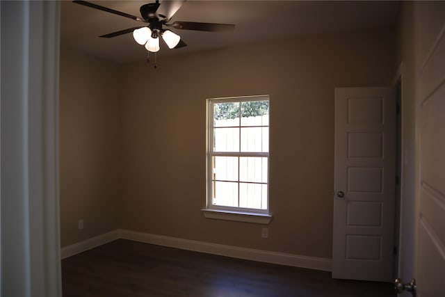 spare room with ceiling fan and dark wood-type flooring