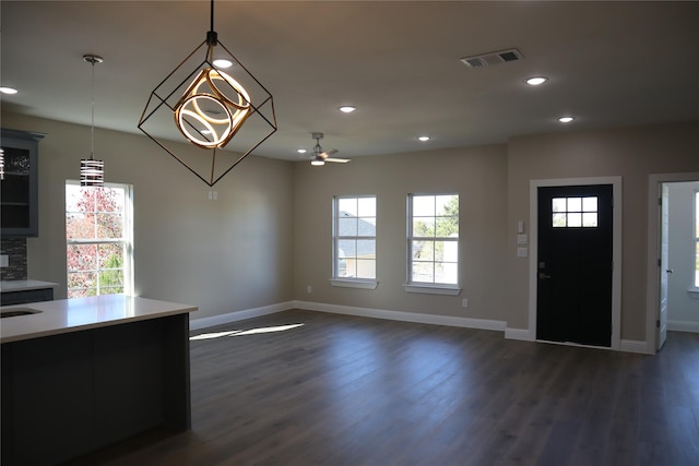 kitchen with dark hardwood / wood-style floors, hanging light fixtures, a healthy amount of sunlight, and ceiling fan