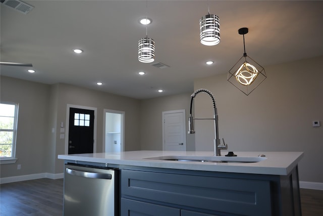 kitchen with a kitchen island with sink, dishwasher, pendant lighting, and dark hardwood / wood-style floors