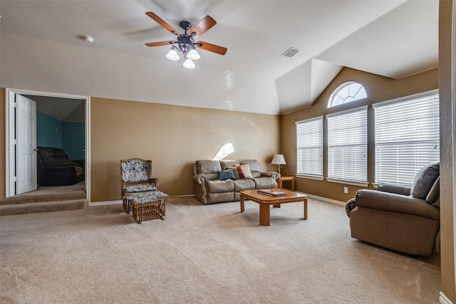 carpeted living room with ceiling fan and lofted ceiling