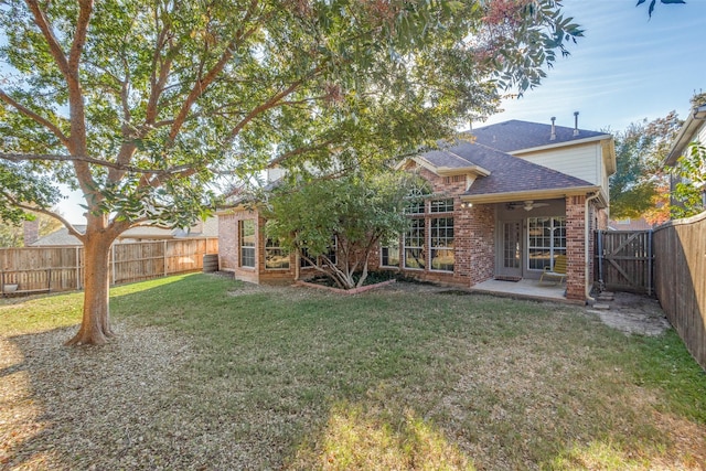 rear view of house with a yard