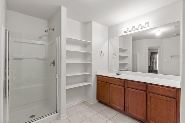 bathroom featuring tile patterned flooring, vanity, and an enclosed shower