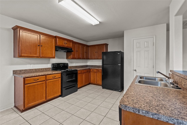 kitchen featuring black appliances, light tile patterned floors, sink, and a textured ceiling