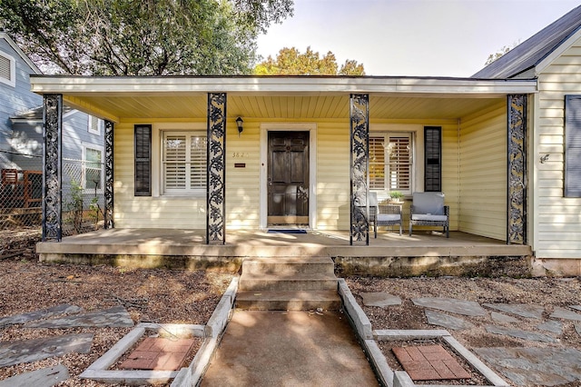 view of exterior entry featuring a porch