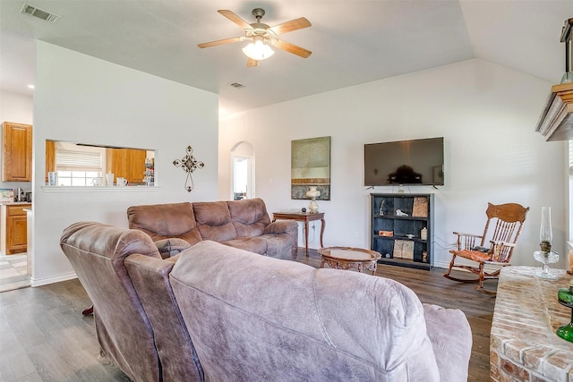 living room featuring ceiling fan, lofted ceiling, and dark hardwood / wood-style flooring