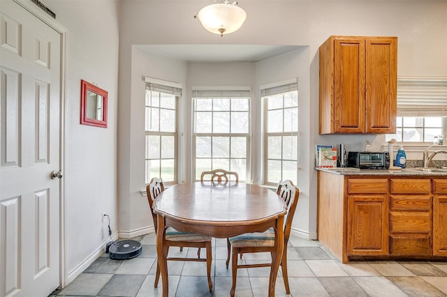 tiled dining space featuring sink