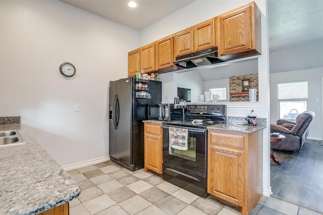 kitchen featuring range hood, sink, and black appliances