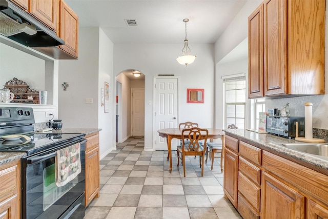 kitchen with pendant lighting, decorative backsplash, light tile patterned floors, and black range with electric cooktop