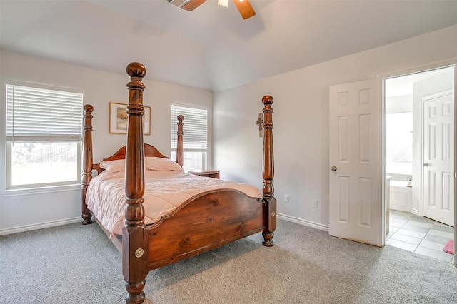 carpeted bedroom with ceiling fan, connected bathroom, and vaulted ceiling