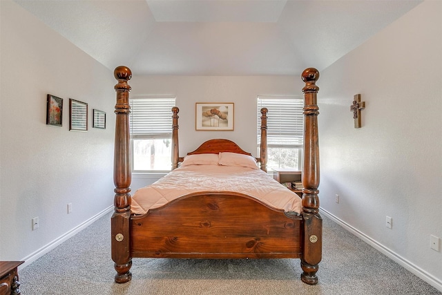 bedroom featuring carpet floors, multiple windows, and lofted ceiling