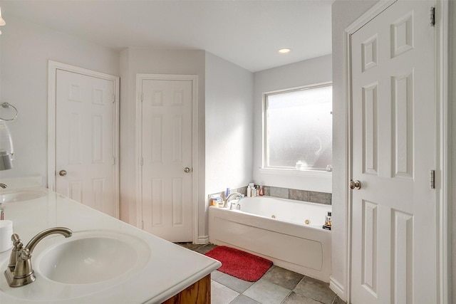 bathroom with vanity and a tub