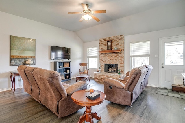 living room with a brick fireplace, dark hardwood / wood-style floors, vaulted ceiling, and ceiling fan