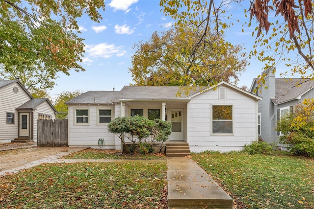 bungalow-style house with a front yard