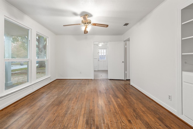 unfurnished room with ceiling fan and dark wood-type flooring