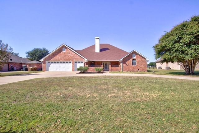 view of front of home with a garage and a front lawn