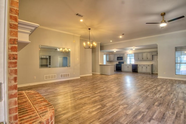 unfurnished living room featuring hardwood / wood-style floors, ceiling fan with notable chandelier, and crown molding