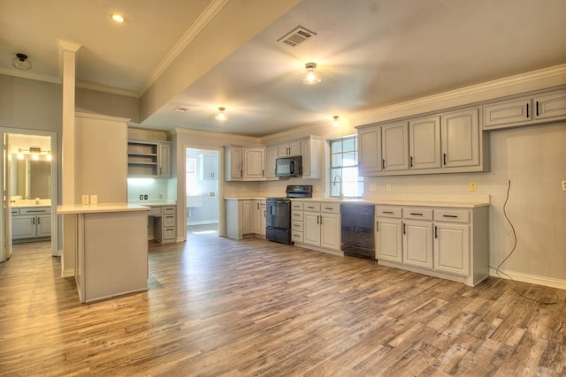 kitchen featuring a center island, black appliances, gray cabinets, ornamental molding, and light hardwood / wood-style floors