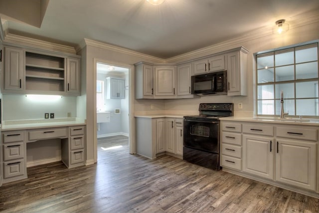 kitchen with gray cabinetry, black appliances, sink, ornamental molding, and wood-type flooring