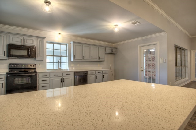 kitchen featuring light stone countertops, gray cabinets, crown molding, and black appliances