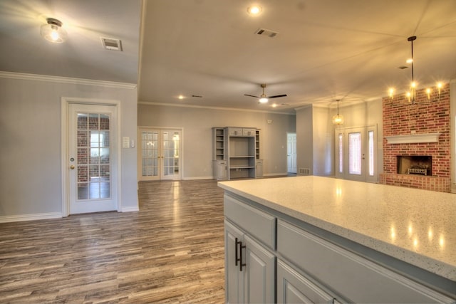 kitchen featuring hardwood / wood-style floors, hanging light fixtures, a wealth of natural light, and french doors