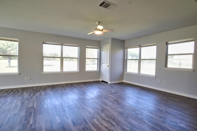 unfurnished room with ceiling fan, plenty of natural light, and dark hardwood / wood-style floors