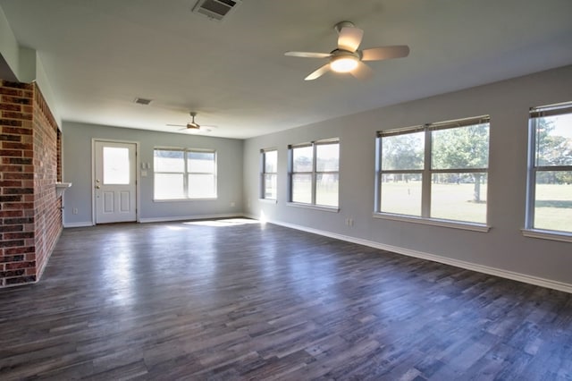 unfurnished living room featuring ceiling fan, a fireplace, and dark wood-type flooring