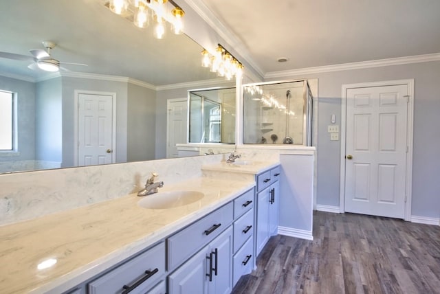 bathroom with hardwood / wood-style flooring, a shower with shower door, and crown molding