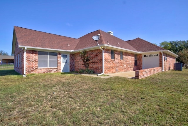 exterior space featuring a garage and a yard