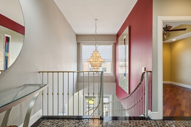 hall with an inviting chandelier