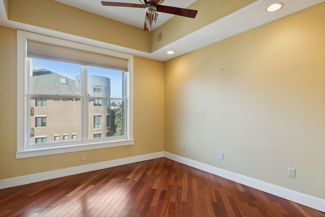 empty room featuring ceiling fan and dark hardwood / wood-style flooring