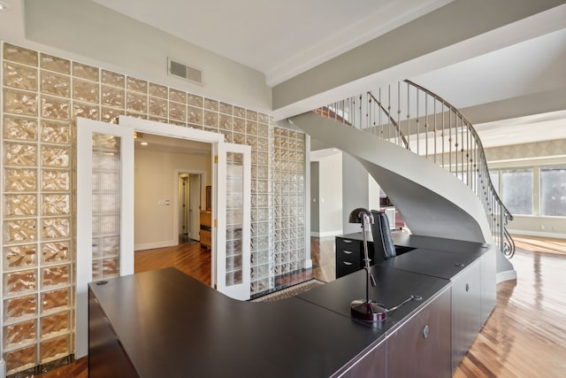 kitchen featuring dark brown cabinets and wood-type flooring