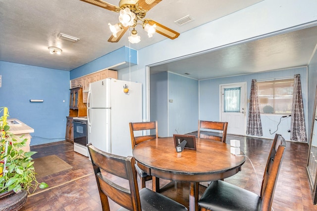 dining room featuring sink, ceiling fan, dark hardwood / wood-style flooring, and a textured ceiling