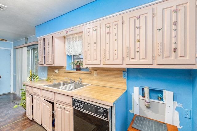 kitchen with black dishwasher, tasteful backsplash, and sink