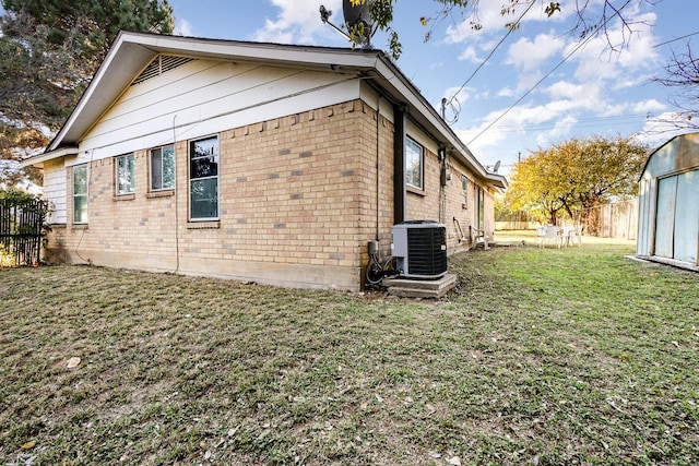 view of property exterior with a yard and central AC unit