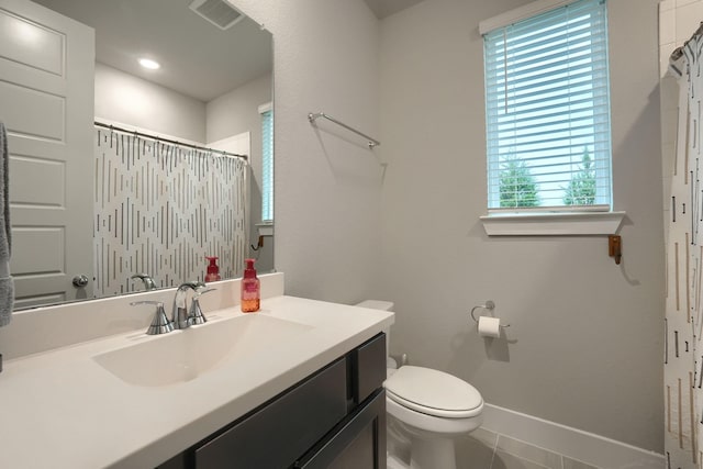 bathroom with toilet, a shower with curtain, vanity, and tile patterned floors