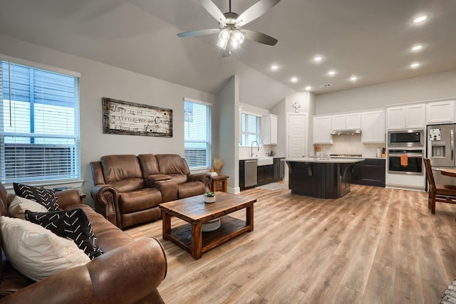 kitchen featuring stainless steel dishwasher, ceiling fan, sink, light hardwood / wood-style flooring, and white cabinetry