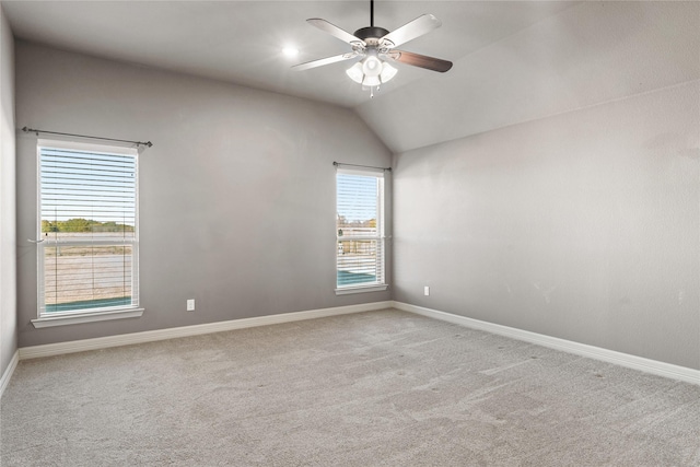 unfurnished bedroom featuring ceiling fan, light colored carpet, and lofted ceiling