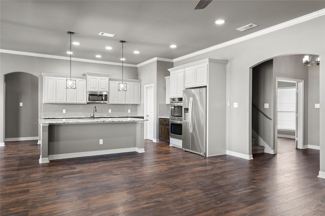 kitchen featuring visible vents, arched walkways, appliances with stainless steel finishes, and dark wood-style floors
