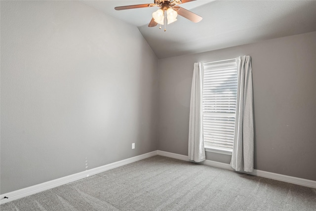 carpeted empty room featuring ceiling fan and lofted ceiling