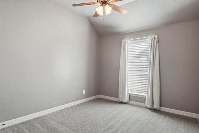 unfurnished room featuring baseboards, carpet, a ceiling fan, and vaulted ceiling
