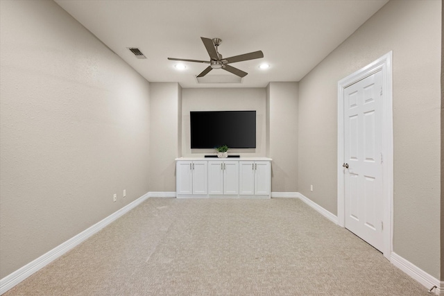 unfurnished living room with light carpet and ceiling fan