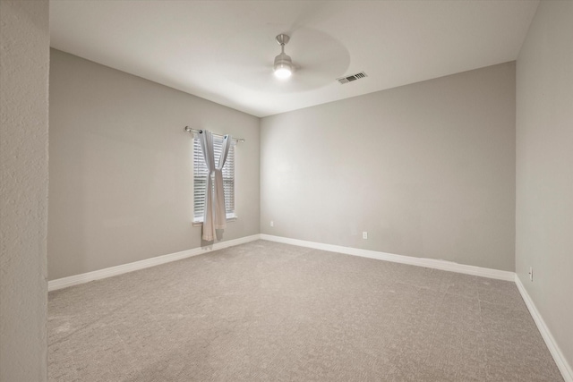 empty room featuring carpet flooring and ceiling fan