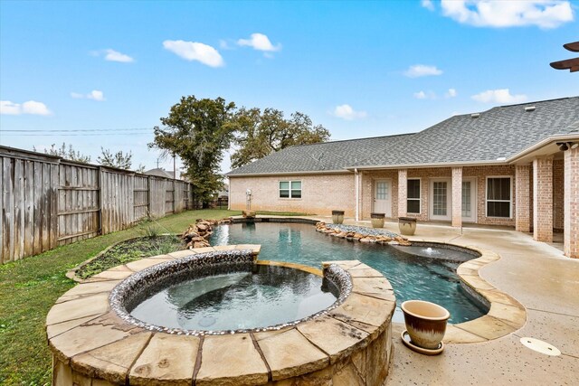 view of pool featuring a patio area and an in ground hot tub